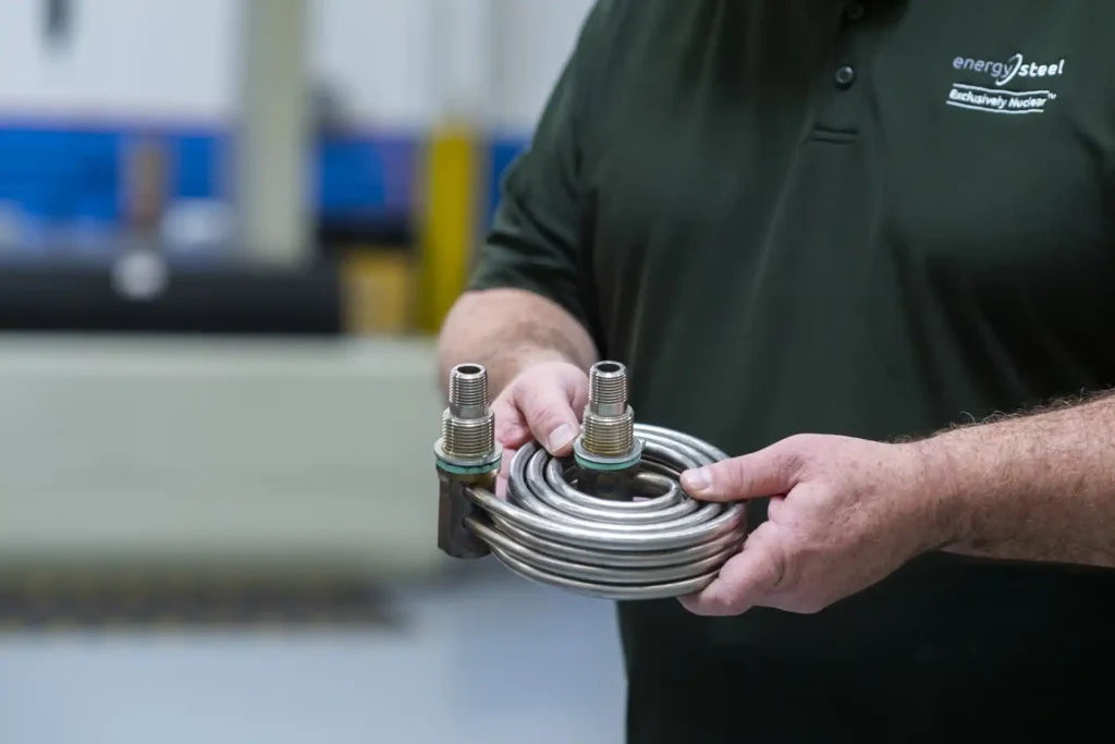 energy steel worker holding heat exchanger