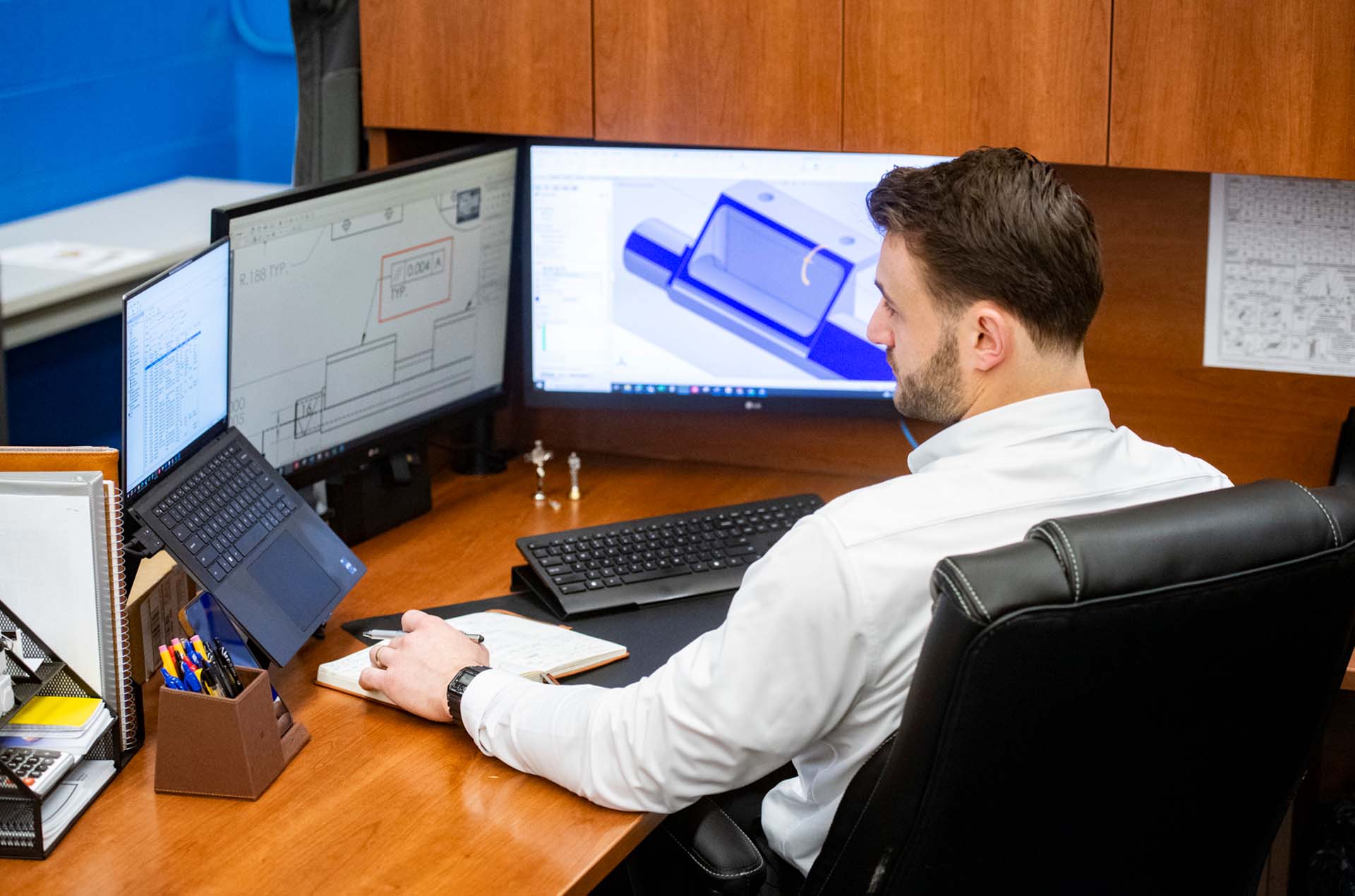 energy steel engineer at desk working on laptop