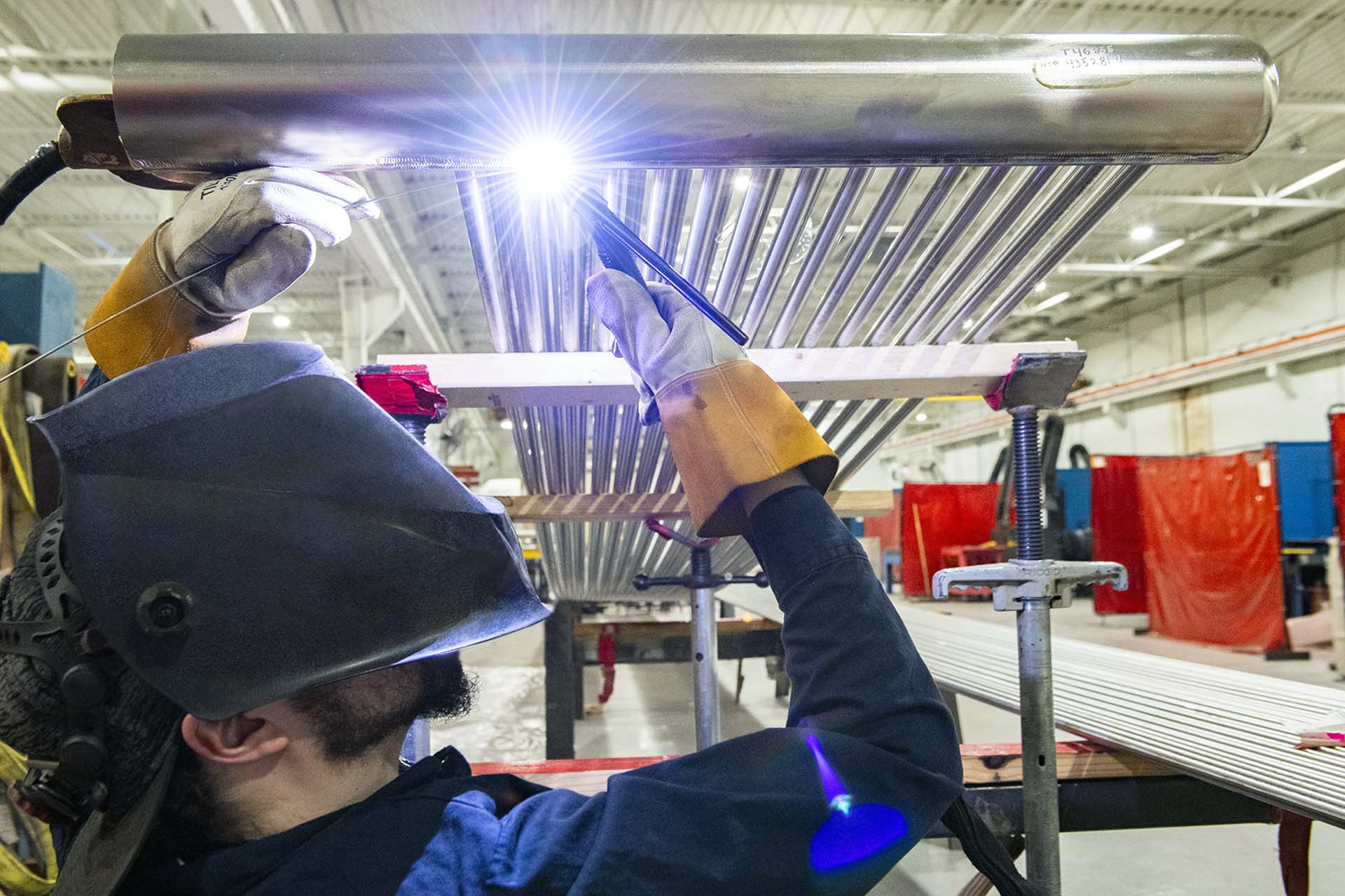 energy steel worker welding overhead