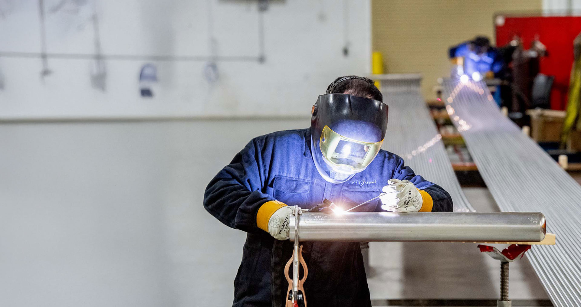 energy steel worker welding pipe