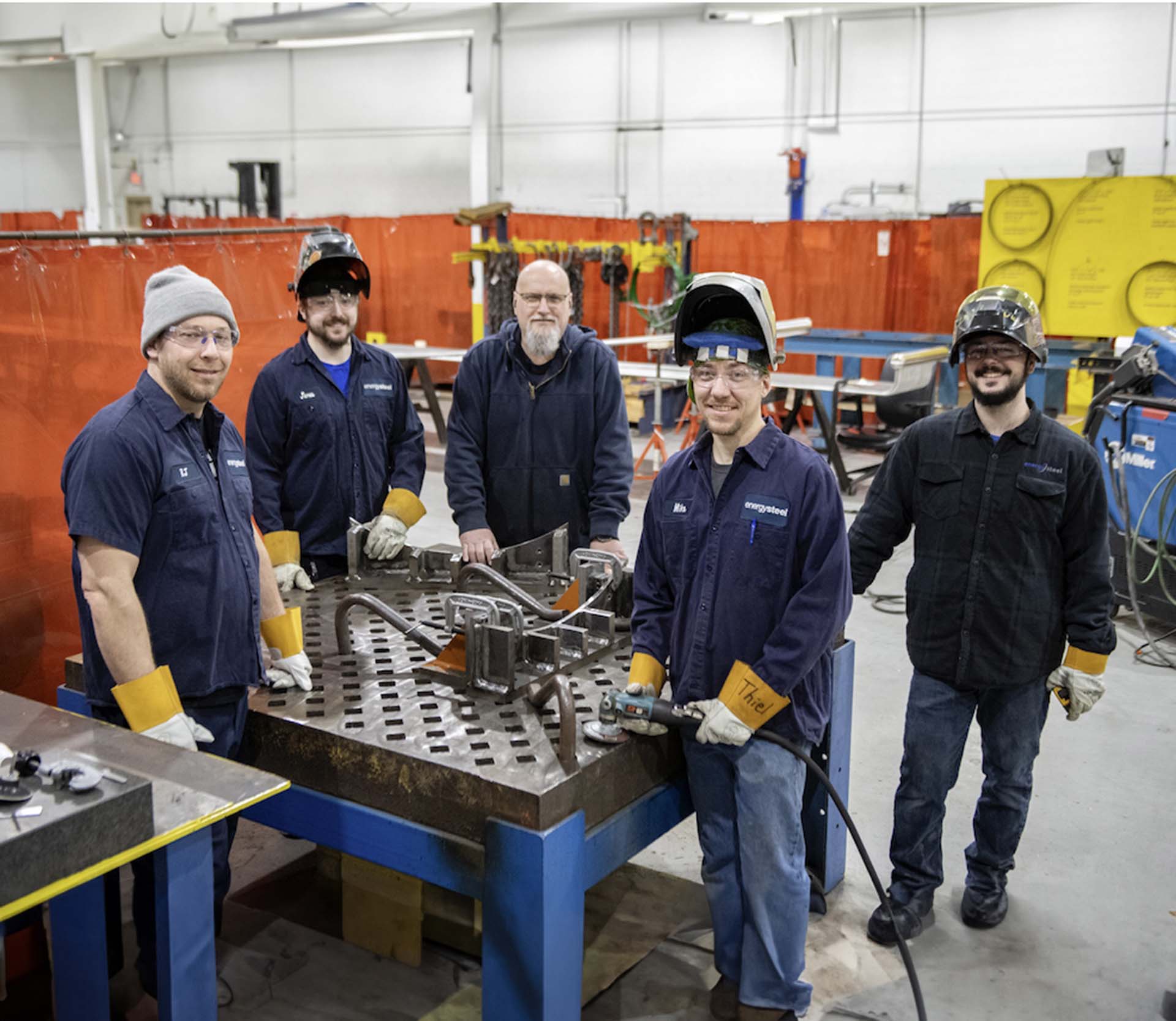 group of energy steel workers at a table